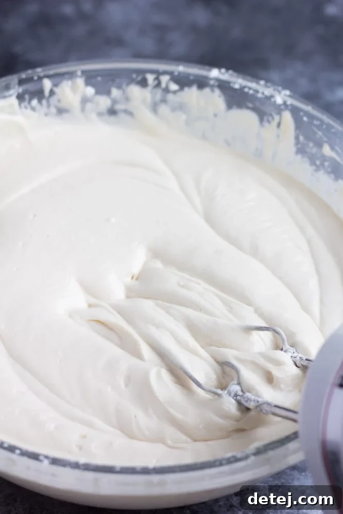 A bowl of vegan cream cheese frosting captured before the chilling process, demonstrating its initial soft and creamy texture.