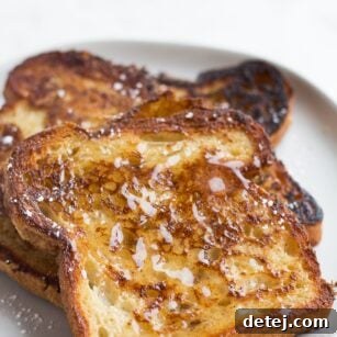 vegan french toast on a plate with syrup on it.