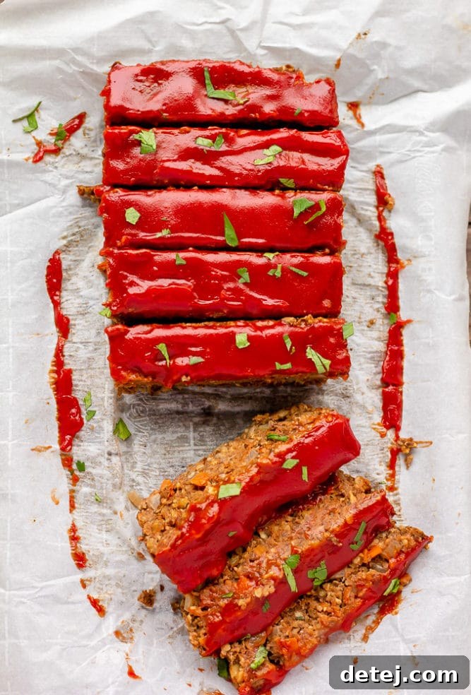 looking down on a lentil loaf sliced with green herbs on top