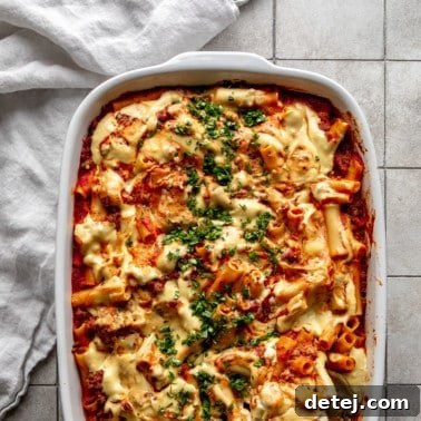 Close up on Vegan Baked Ziti in a large casserole dish, showing the rich texture and melted cheese.
