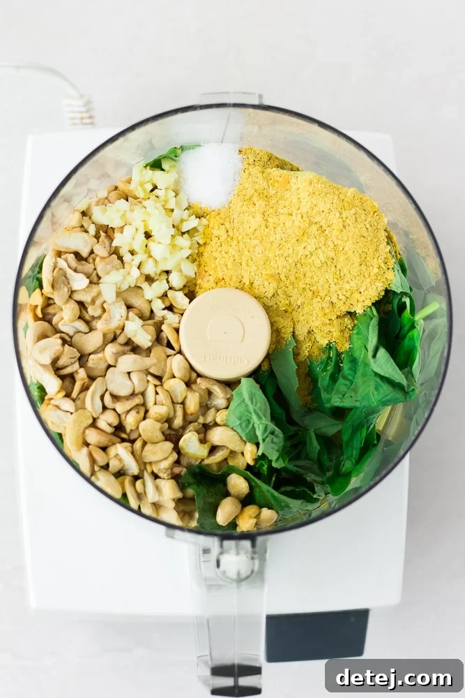 ingredients for vegan pesto in food processor before being blended.