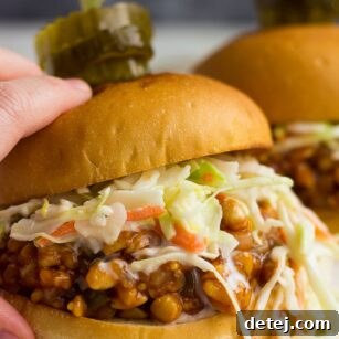 hand holding bbq tempeh sandwich