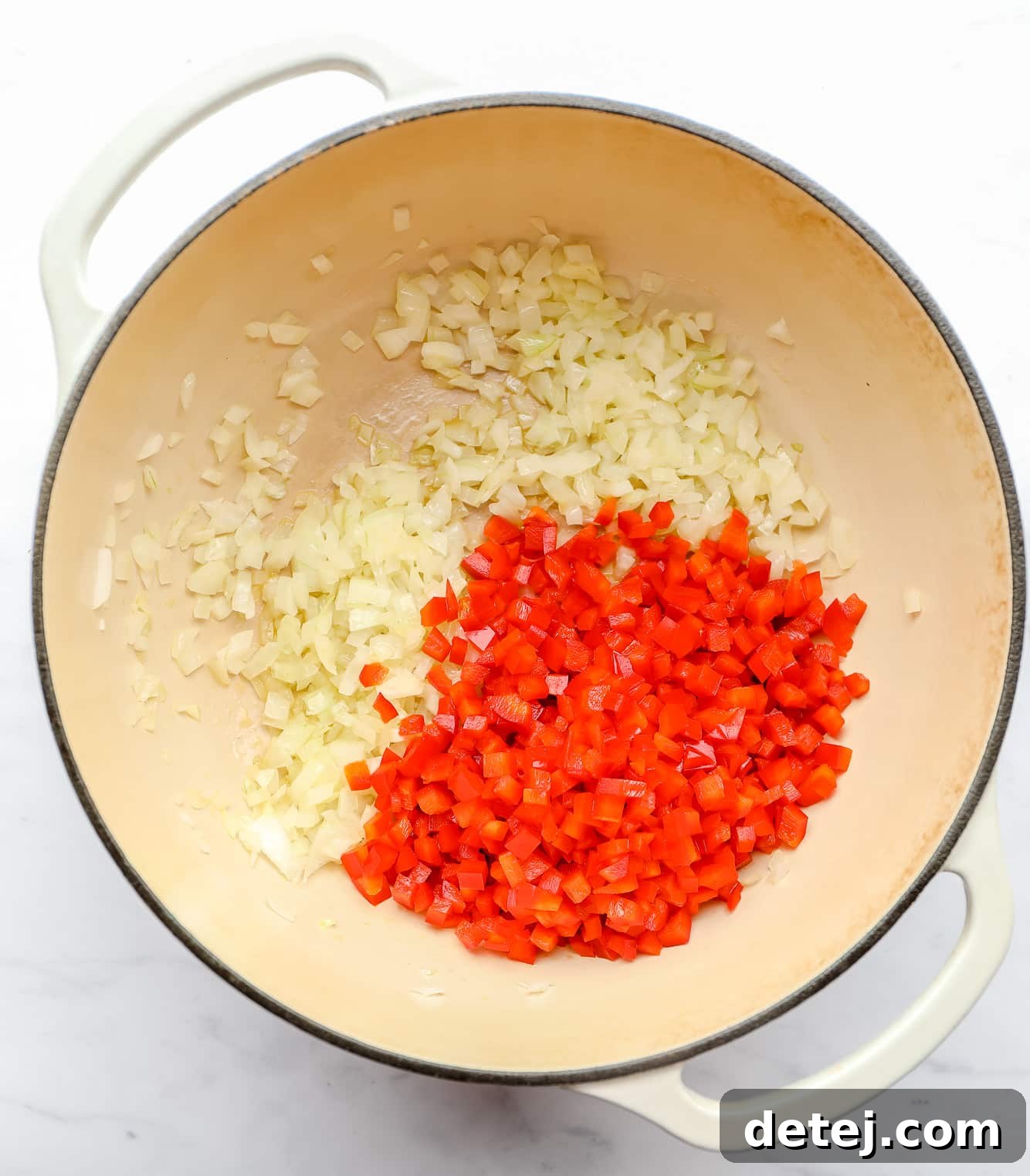 sautéing diced onion and red bell pepper in a large soup pot.