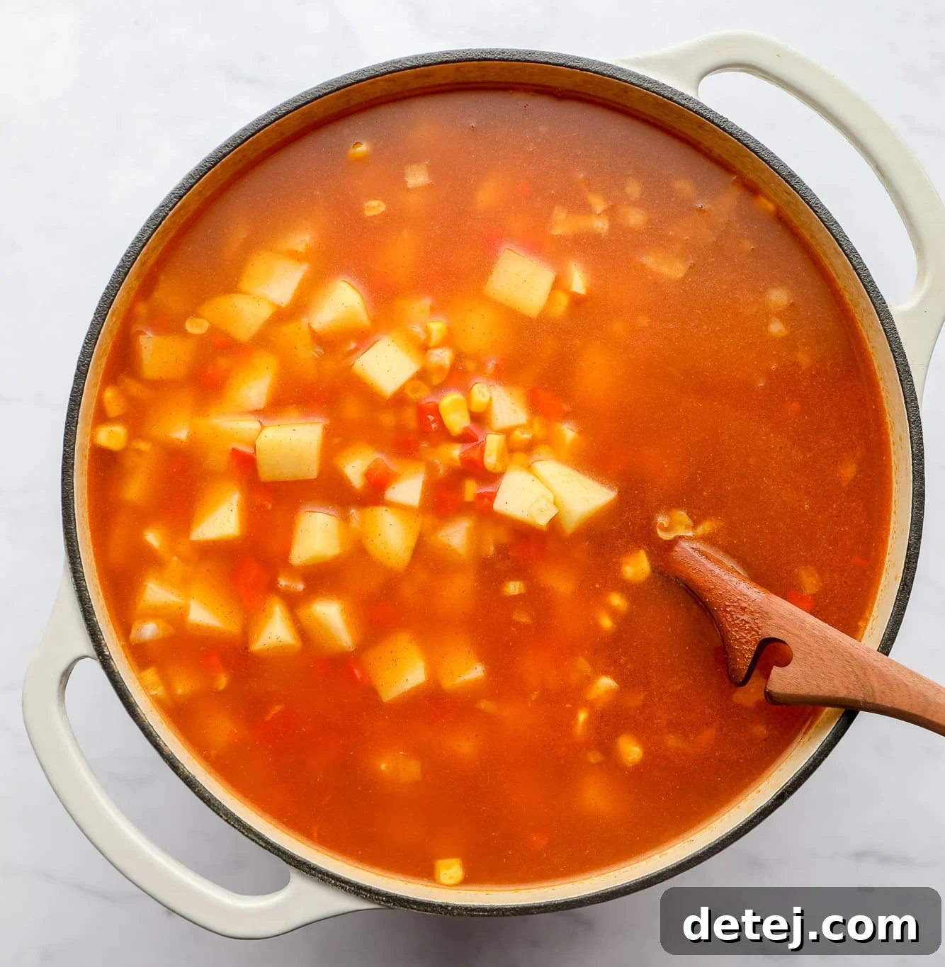 cooking vegan corn chowder in a large soup pot.