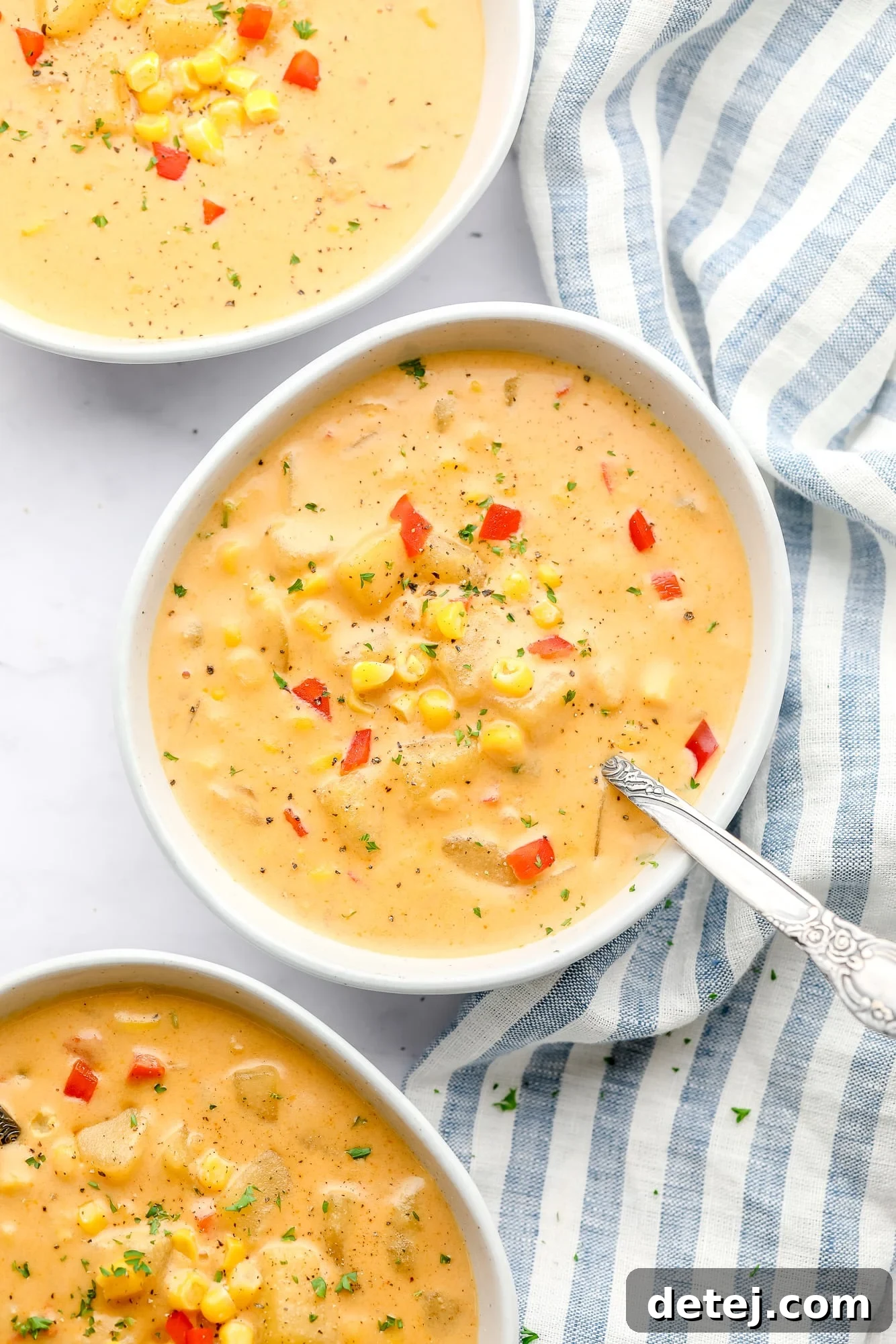 3 bowls of vegan corn chowder next to each other.