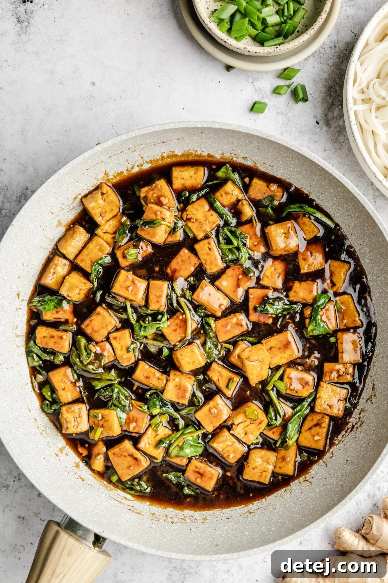 Effortless One Pan Tofu Stir Fry 7 cooked tofu and spinach in a skillet with brown sauce.