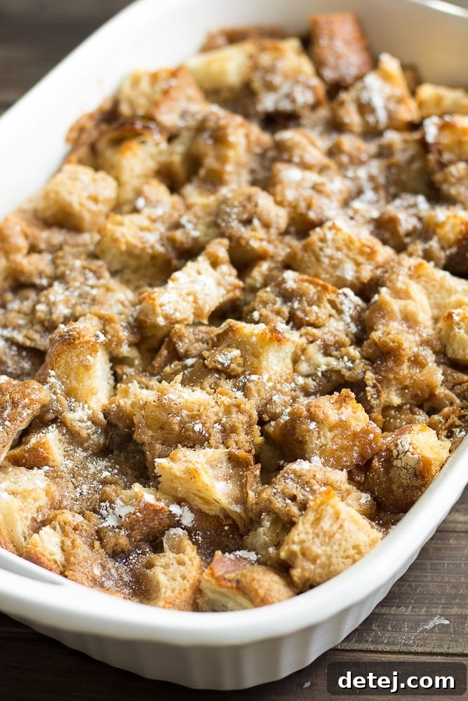 Ultimate Vegan French Toast Bake 4 A vibrant, golden vegan French toast casserole sits baked to perfection in a classic white casserole dish, ready to be served.