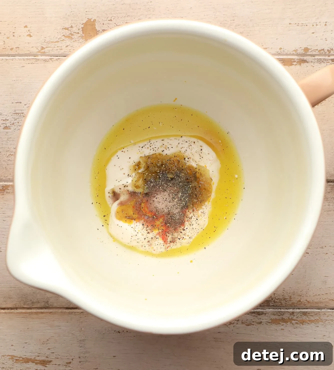ingredients for tofu egg salad dressing neatly arranged in a large white bowl, ready to be mixed.