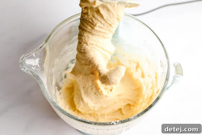 Soft, kneaded dough resting in a stand mixer bowl.