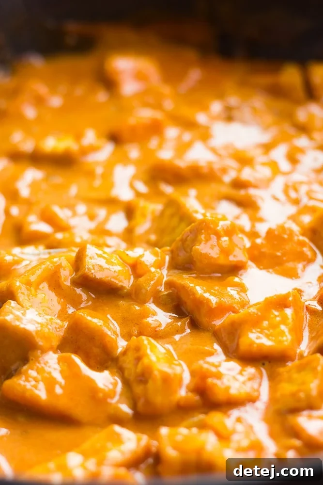 vegan butter chicken in a pan, cooked with sauce.
