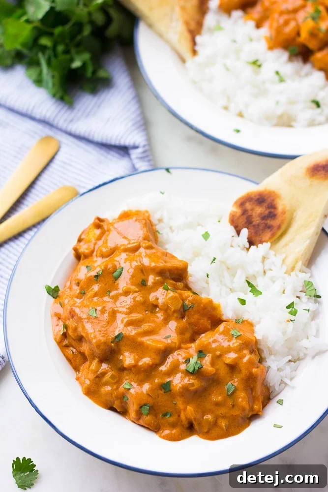 vegan butter chicken in a bowl with rice and naan