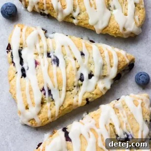 looking down on a few vegan blueberry scones with grey background