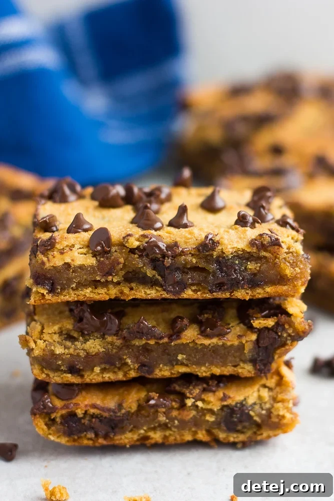 stack of 3 chickpea blondies, golden brown with melted chocolate chips