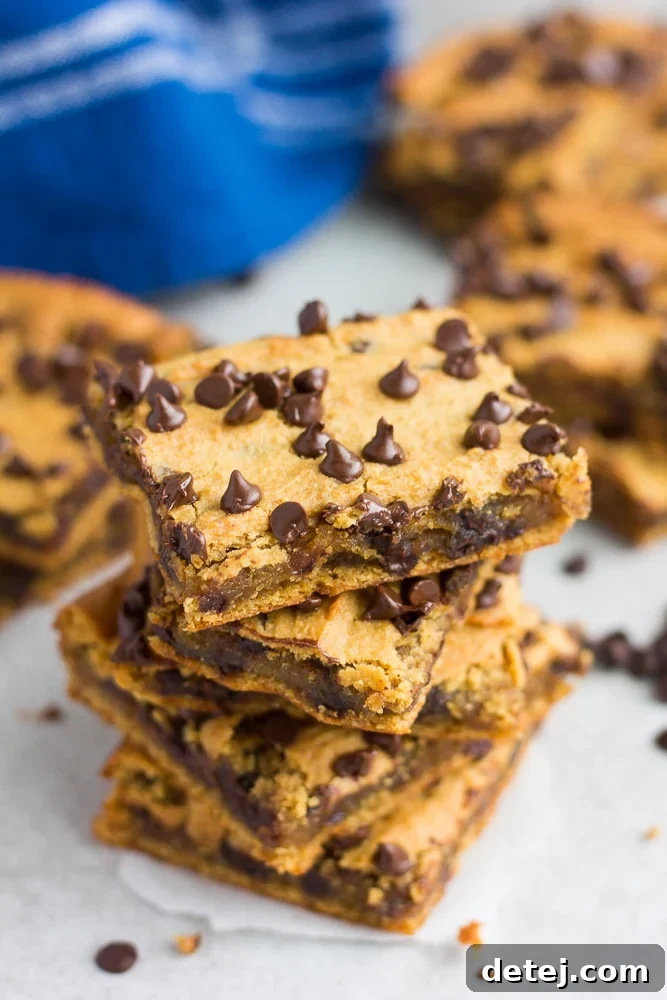 stack of 3 unevenly stacked chickpea blondies with chocolate chips