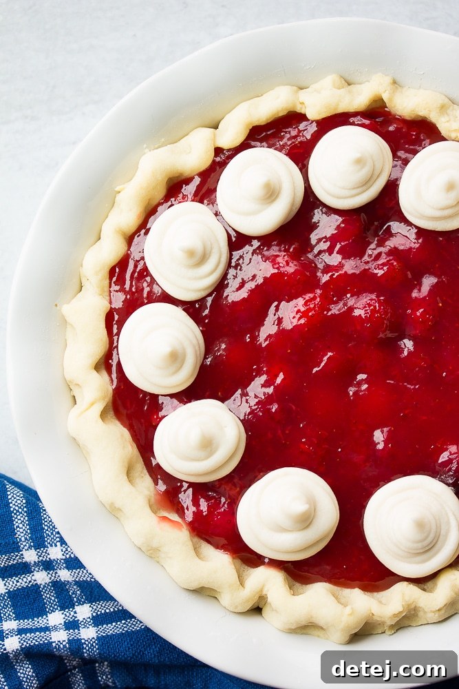 whole vegan strawberry pie, white background, with whip cream.