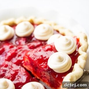 slice of strawberry pie being lifted out of pie plate.