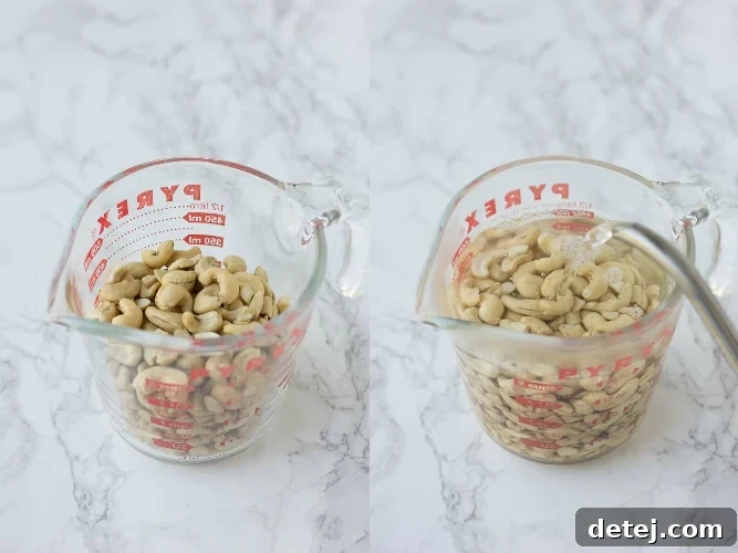Raw cashews soaking in hot water in a bowl.