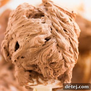 A spatula delicately coated with rich vegan chocolate frosting, ready to be spread or piped.
