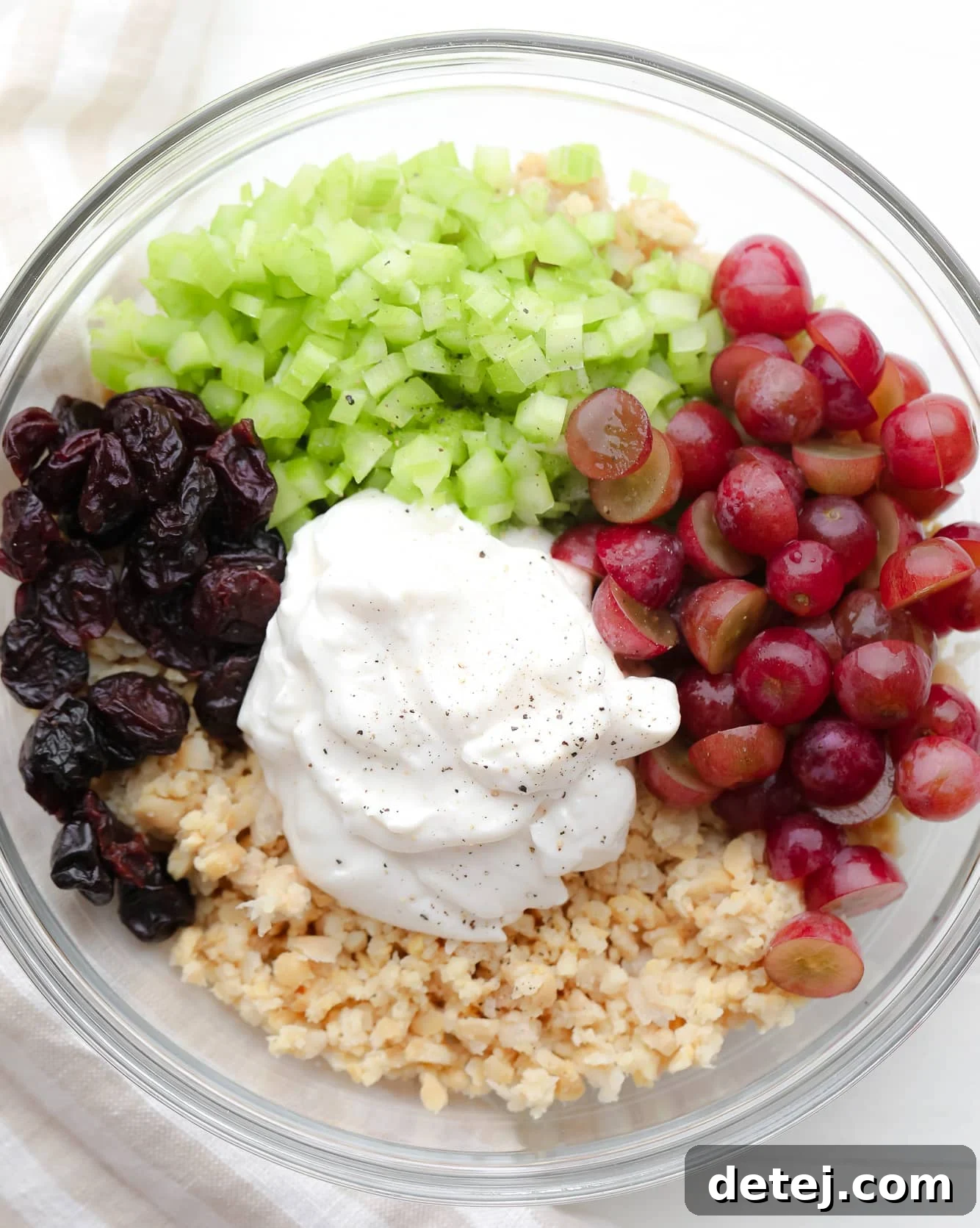 ingredients for vegan chicken salad in a large glass bowl.