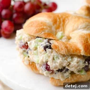 close up on vegan chicken salad in a croissant sandwich.