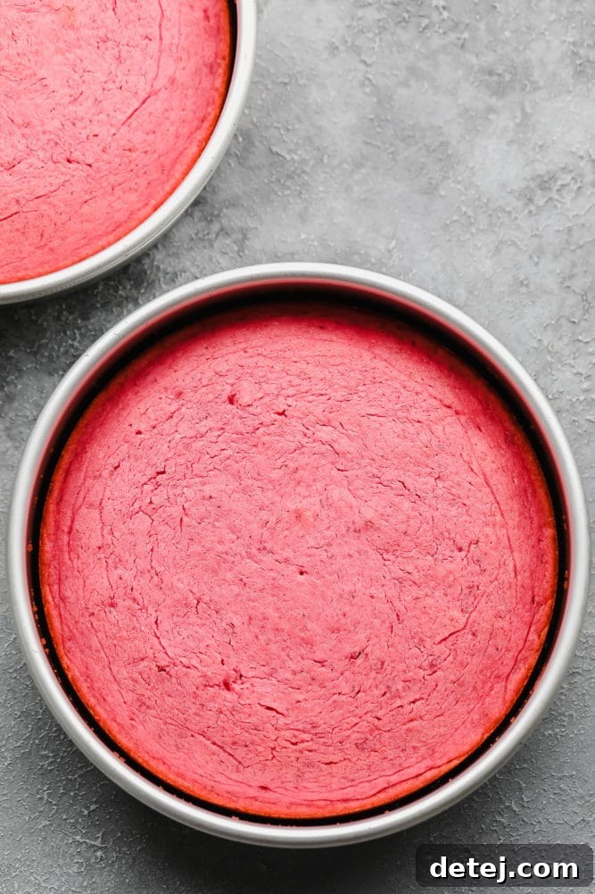 cooked pink cakes in silver pans