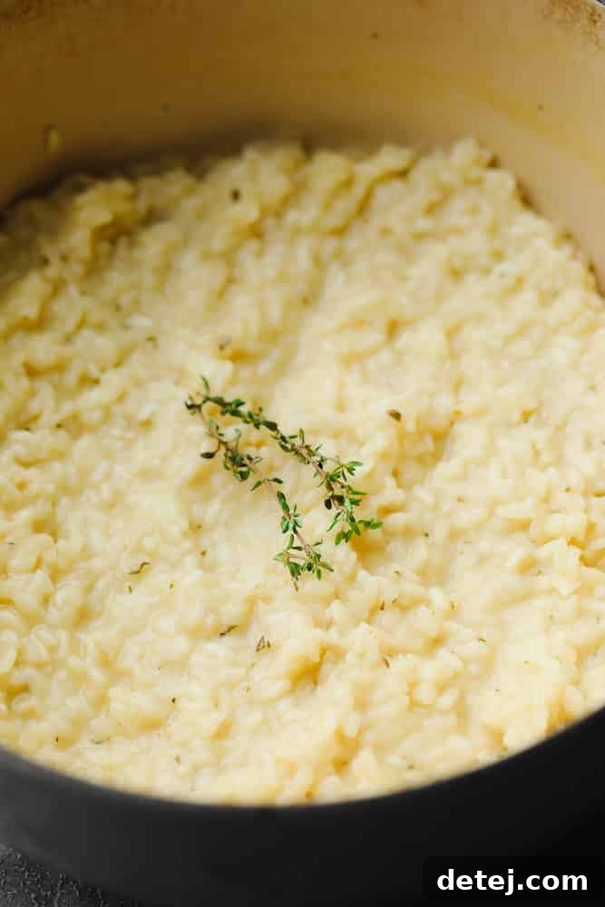showing a pot of cooked rice mixture with thyme on top in a pot