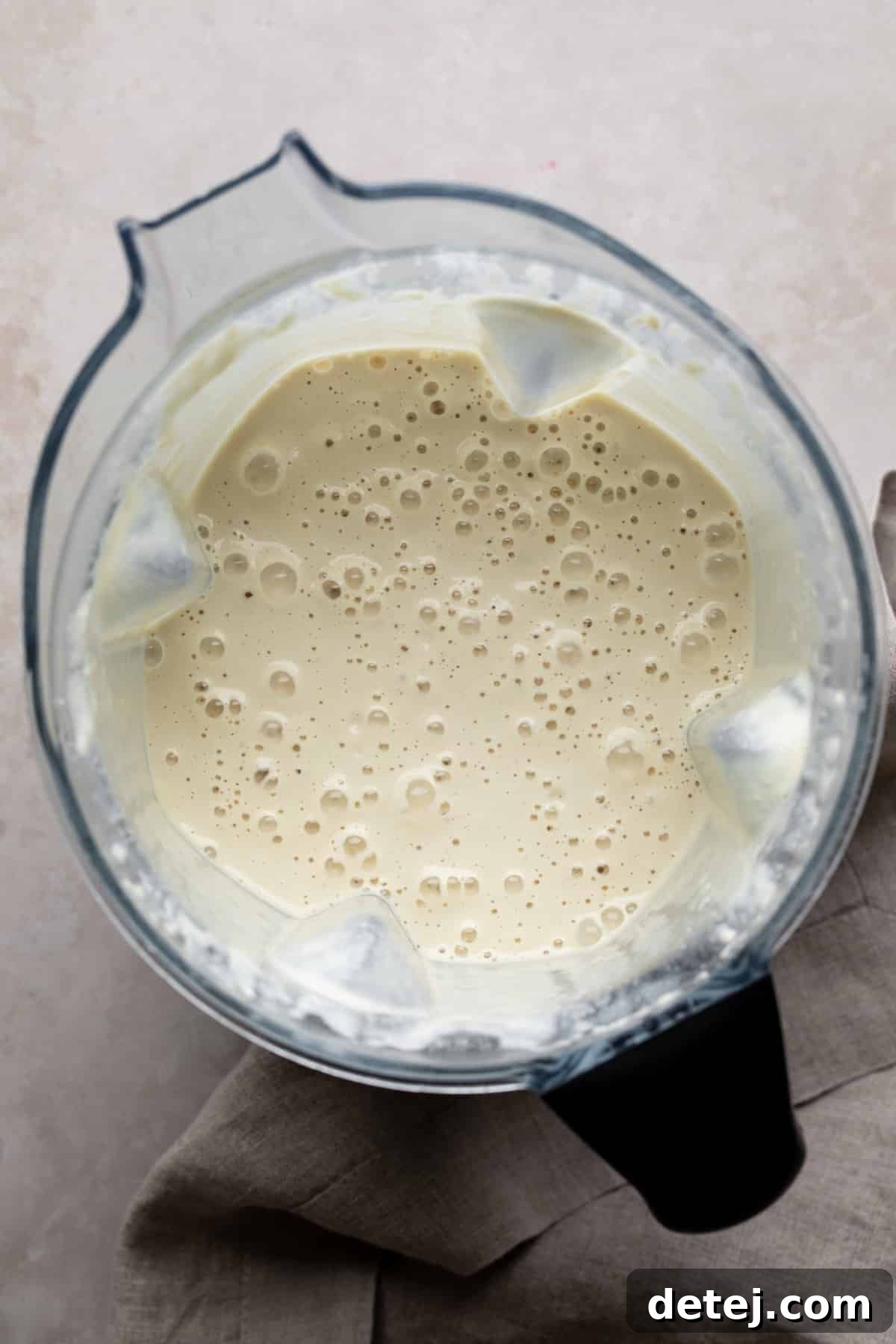 blender with creamy white sauce in it