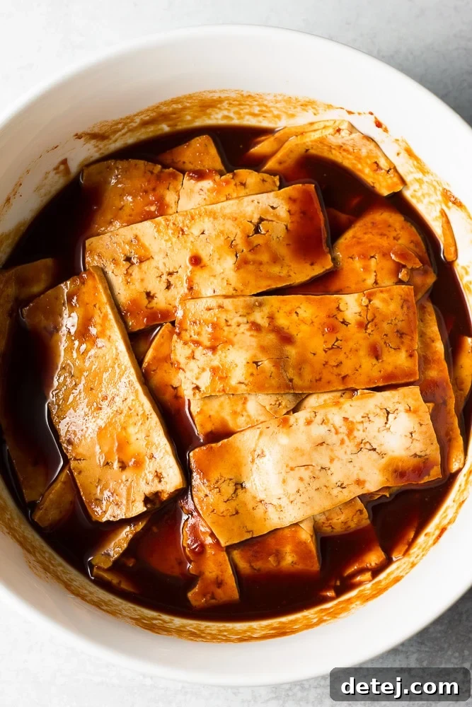tofu marinating in a white bowl