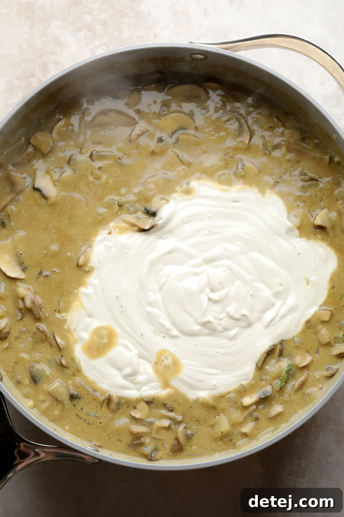 The creamy mushroom gravy for stroganoff after the cashew cream has been added, showing a rich, smooth texture in a large grey pot.
