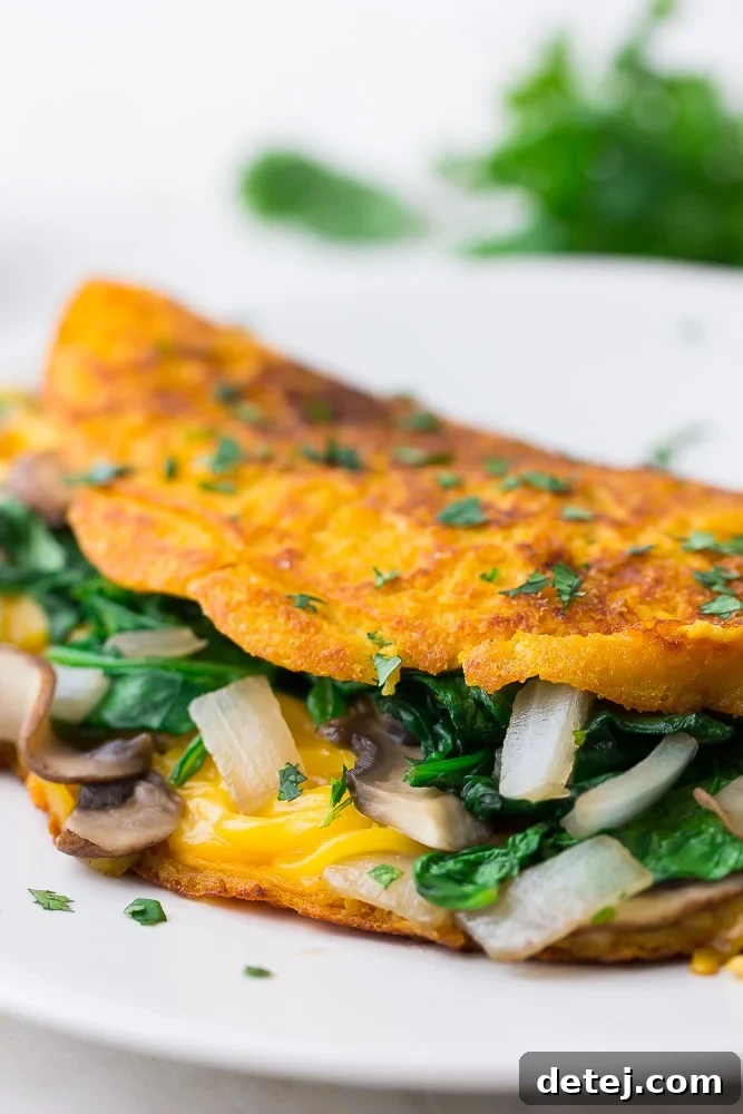 close up of vegan omelette with veggies and cheese inside