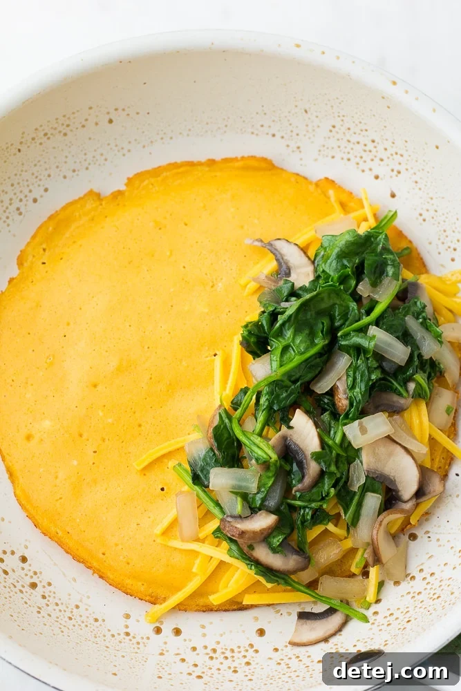 omelette on pan with veggies on it, not flipped over yet