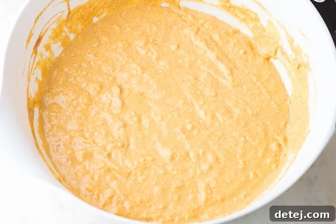 fully mixed vegan pumpkin waffle batter in a bowl, ready for cooking