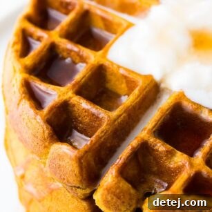 very close up side shot of golden vegan pumpkin waffles