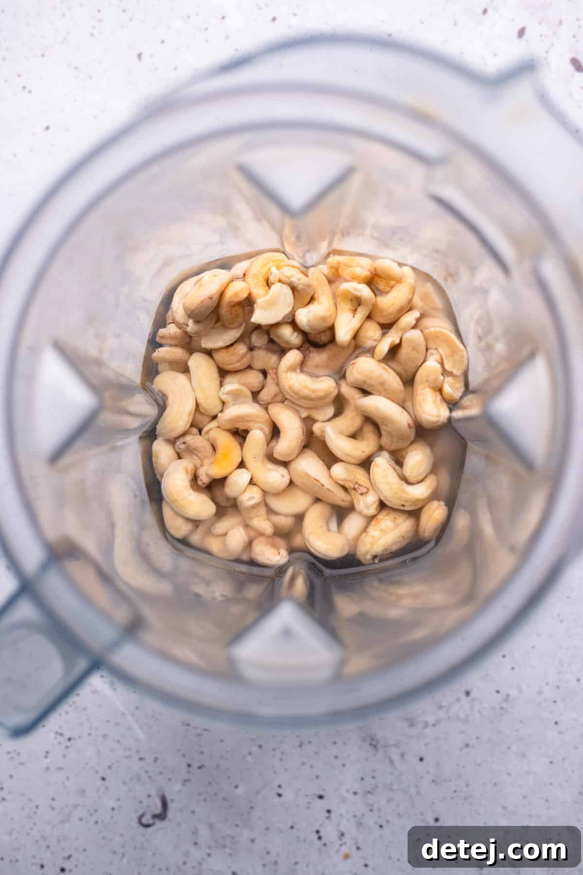 Soaked cashews and fresh water inside a high-powered blender, ready to be transformed into creamy cashew cream.