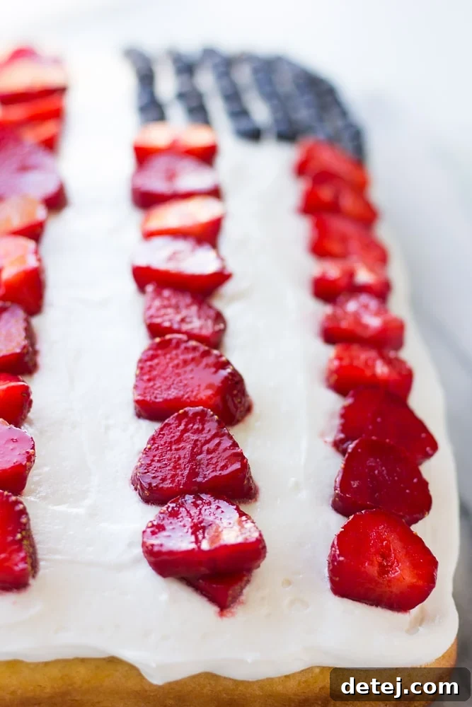 A closer look at the delicious vegan flag cake, showcasing its creamy frosting and fresh berry arrangement.