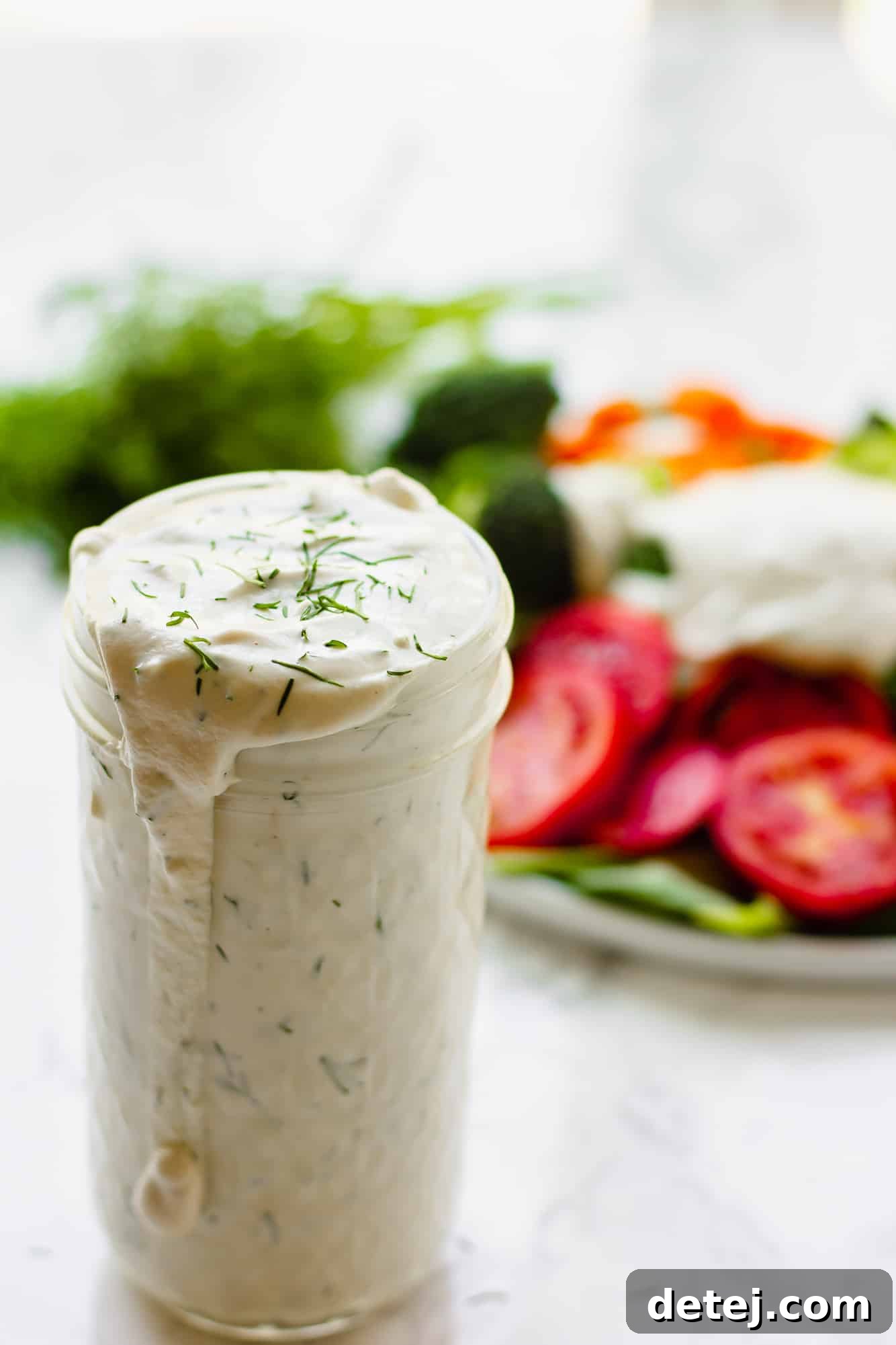 Vegan Ranch Dressing 5 close up on a glass jar filled with vegan ranch dressing.