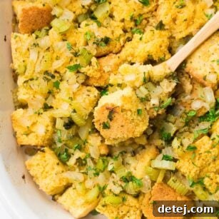 looking down on cornbread stuffing casserole with wooden spoon in it