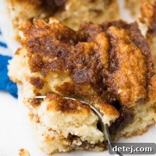 fork taking a bite of vegan coffee cake and blue towel