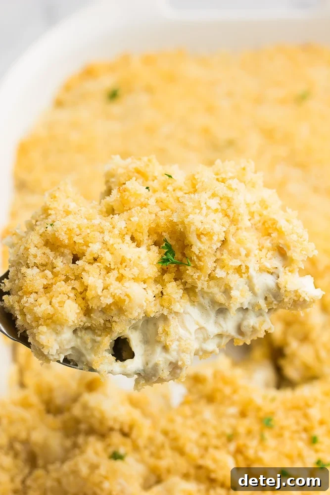 spoon taking a serving out of vegan baked mac and cheese