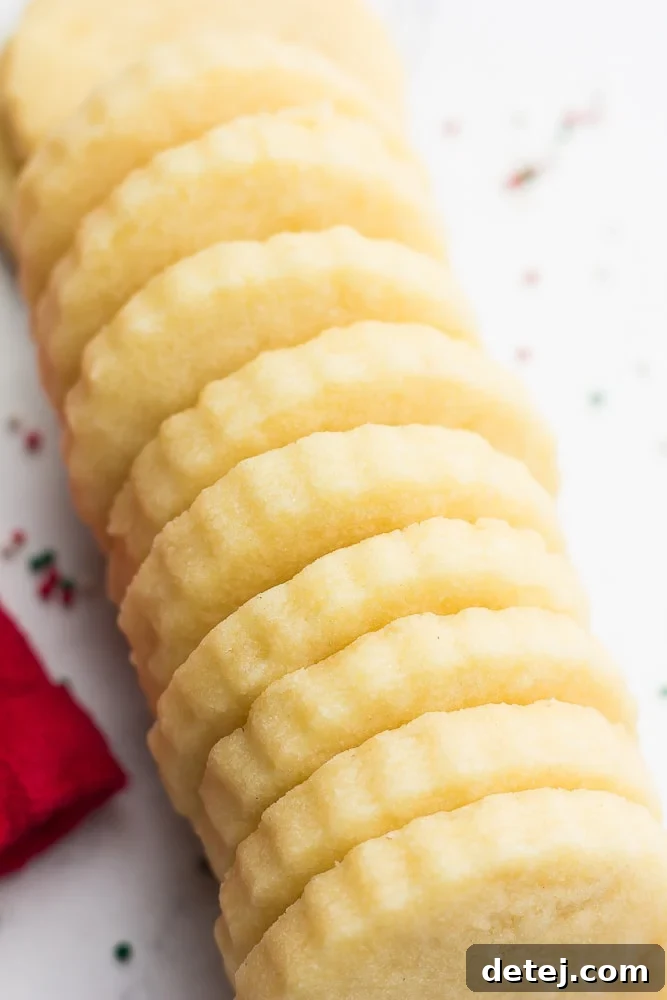 A row of perfectly baked vegan shortbread cookies, showcasing their golden edges and crisp texture.