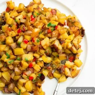 plate filled with breakfast potatoes, sprinkled with parsley.