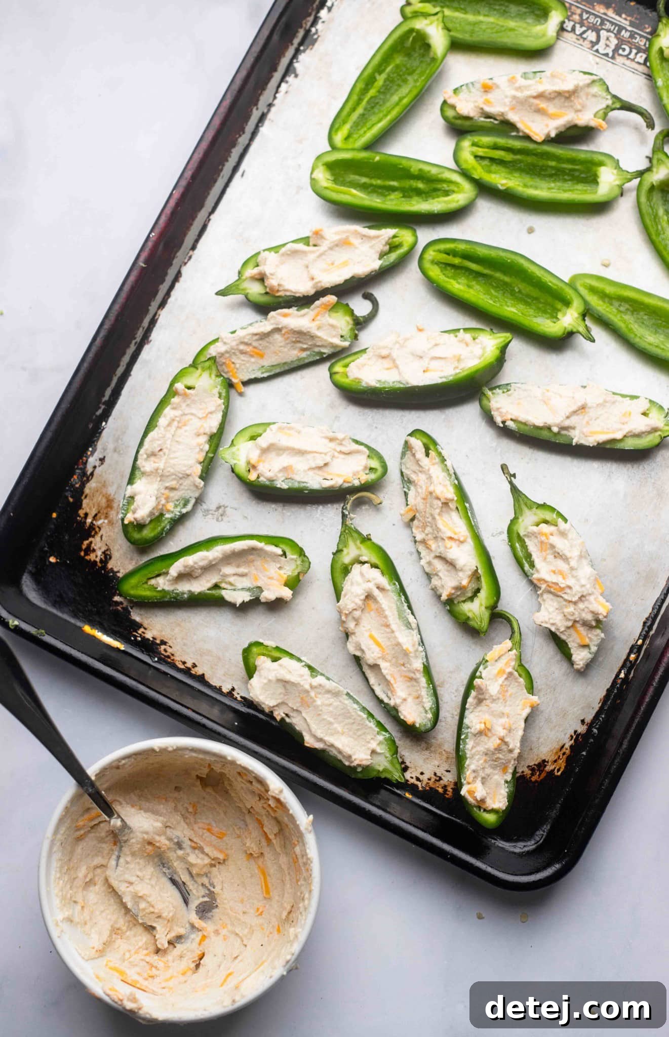 stuffing halved jalapeno peppers with a cream cheese mixture.