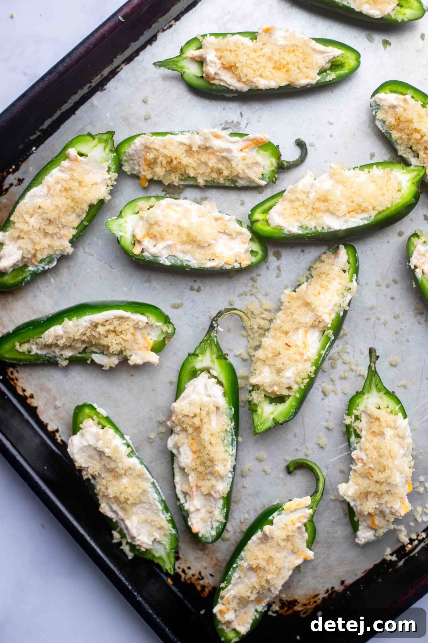 unbaked Vegan Jalapeno Poppers on a baking sheet.
