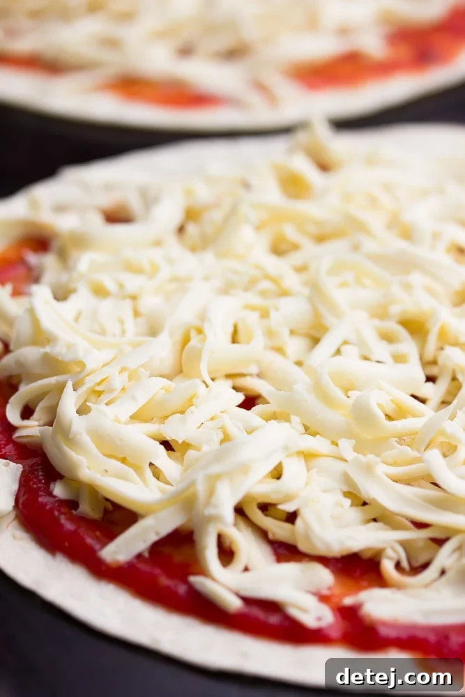 An uncooked pizza base adorned with a rich tomato sauce and a generous layer of freshly shredded vegan mozzarella cheese, ready for baking.