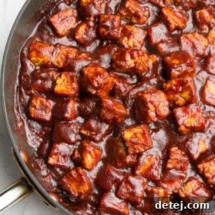 Tempeh cubes coated in barbecue sauce, ready to serve, featured in a recipe card thumbnail.