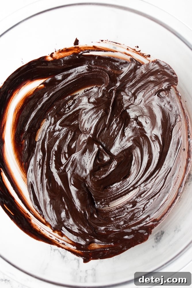 Melted chocolate mixture with vanilla and sugar in a glass bowl