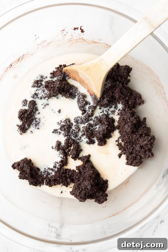 Soy milk being added to the chocolate brownie dough