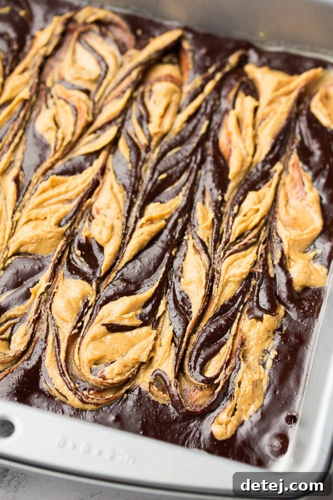 Uncooked peanut butter swirl brownies with marbling pattern