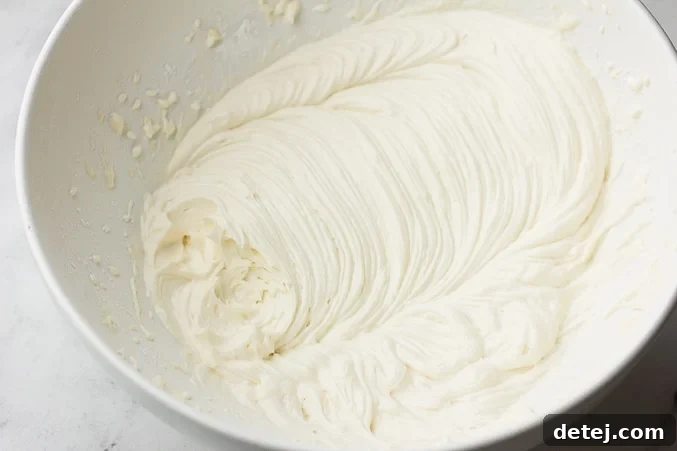 smooth, white vegan frosting in a white bowl, ready for piping