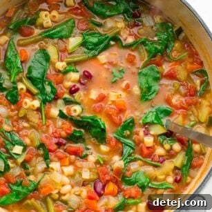 Whole pot of minestrone soup with fresh green spinach